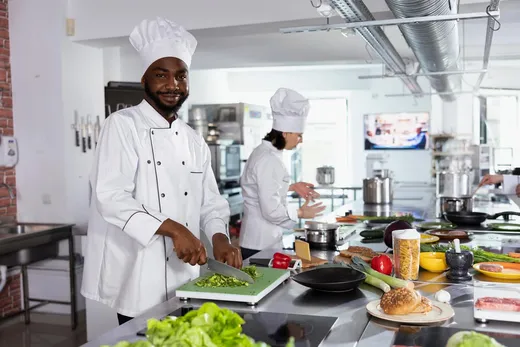 Professional chef preparing fresh vegetables in a commercial kitchen